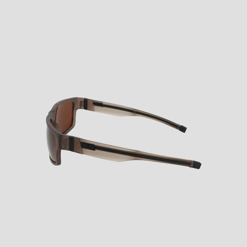 Champion Men's Polarized Retainer Rectangle sunglasses are shown in brown with wide arms, slightly tilted to the right. Featuring polarized lenses for enhanced clarity and glare reduction, they are displayed on a plain light gray background.