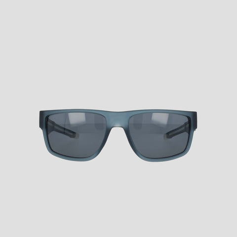 The Champion Men's Polarized Retainer Rectangle sunglasses, shown from the front against a plain light gray background, feature a high-performance frame and dark tinted polarized lenses in a rectangular black design.