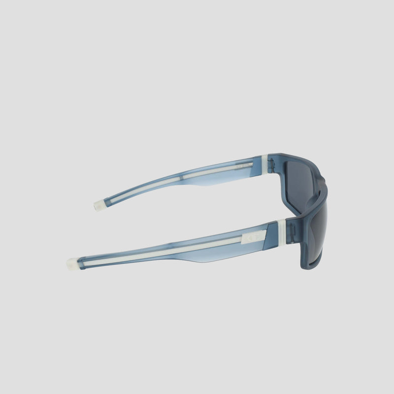 Men's Polarized Retainer Rectangle sunglasses by Champion, featuring blue translucent frames with thick, high-performance retainers and dark polarized lenses crafted from durable TR90 material, displayed from a side angle against a plain white background.
