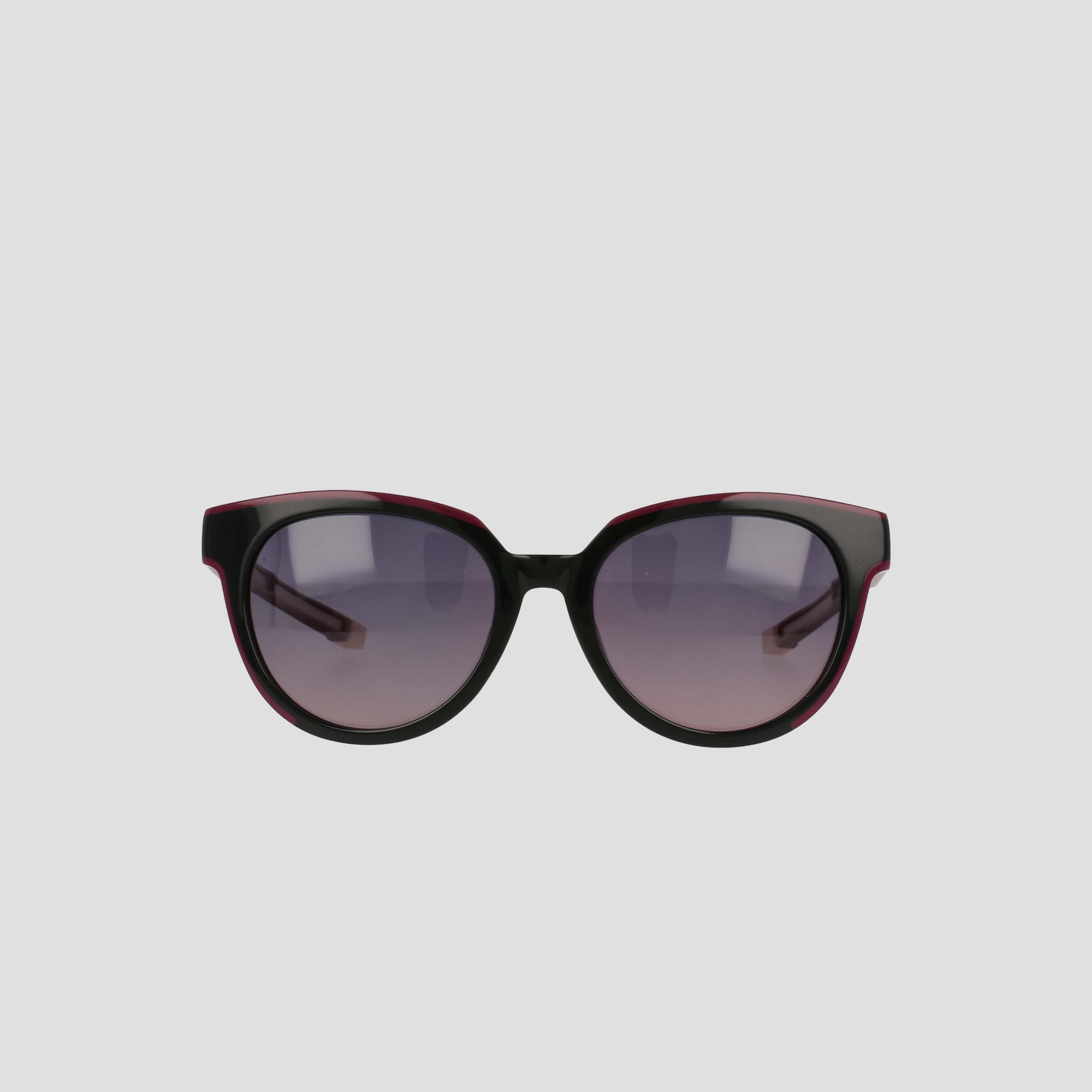 The Champion Women's Polarized Retainer Round sunglasses feature black, round cateye frames and gradient gray lenses, showcased on a light gray background—a stylish and chic choice in women’s eyewear.