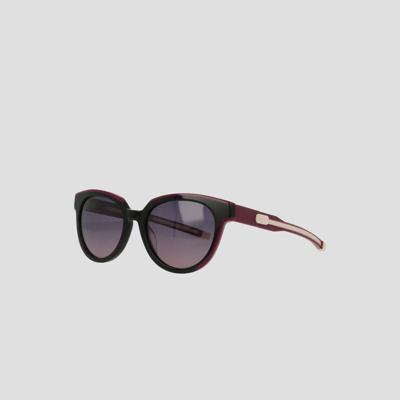 The Champion Women's Polarized Retainer Round sunglasses feature black and dark purple frames with gradient tinted lenses, perfect for women's fashion, displayed on a plain light gray background.