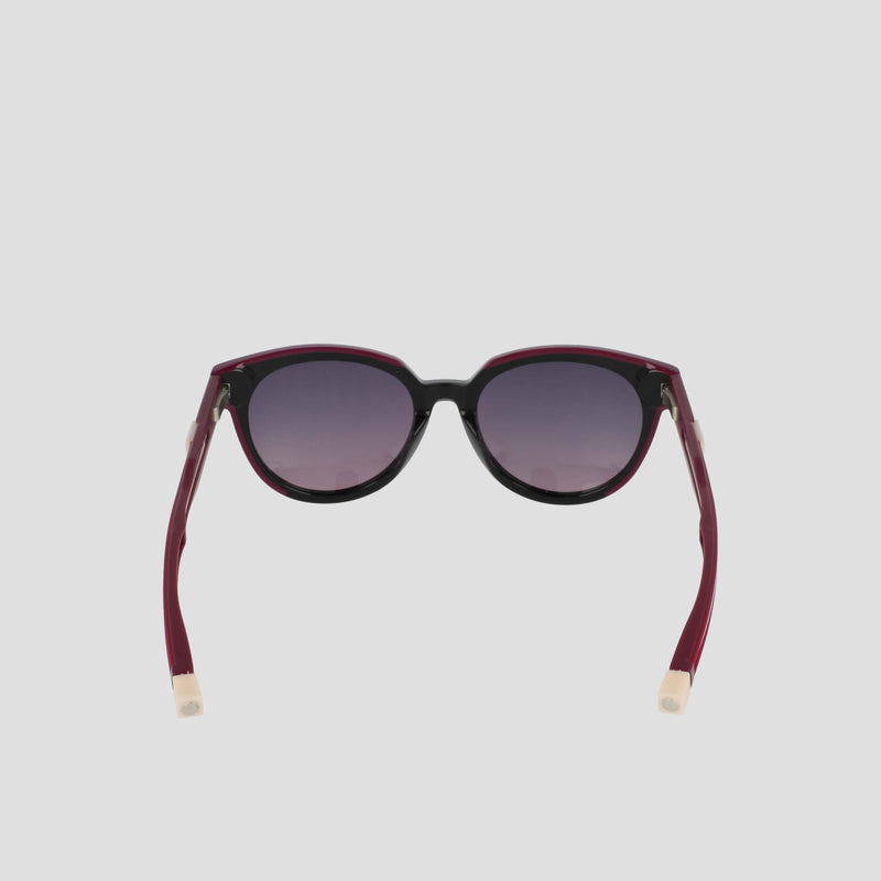 The Champion Women's Polarized Retainer Round eyewear features dark round lenses, a black front frame, and maroon arms with beige tips, displayed on a plain light gray background.