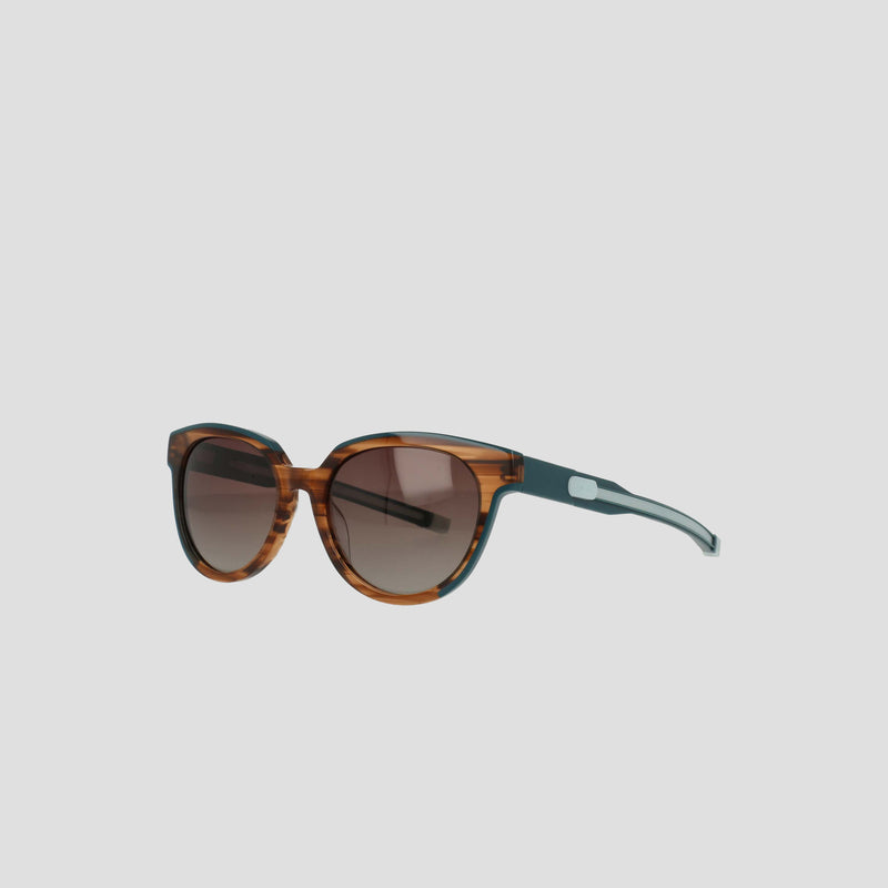 The Champion Women's Polarized Retainer Round eyewear features brown tortoiseshell frames, round polarized lenses, and black temples, displayed on a plain light gray background.