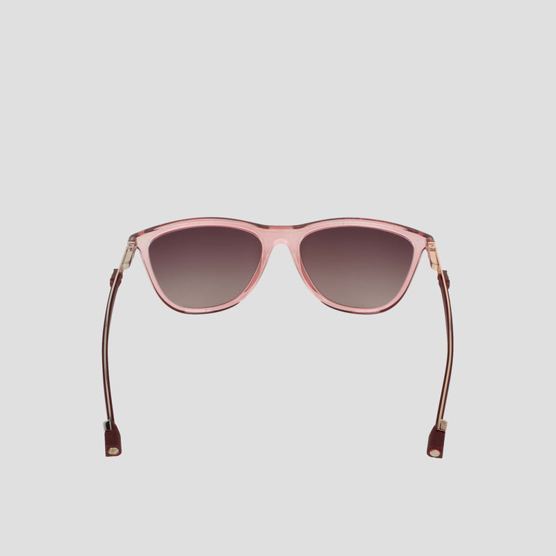 Champion Women's Polarized Retainer Rectangle sunglasses are displayed facing forward, showcasing their pink cateye frames with dark polarized lenses. The arms are extended outward and finished with brown leather or fabric ends. Set against a plain light gray background, these athleisure eyewear frames from Champion stand out in style.