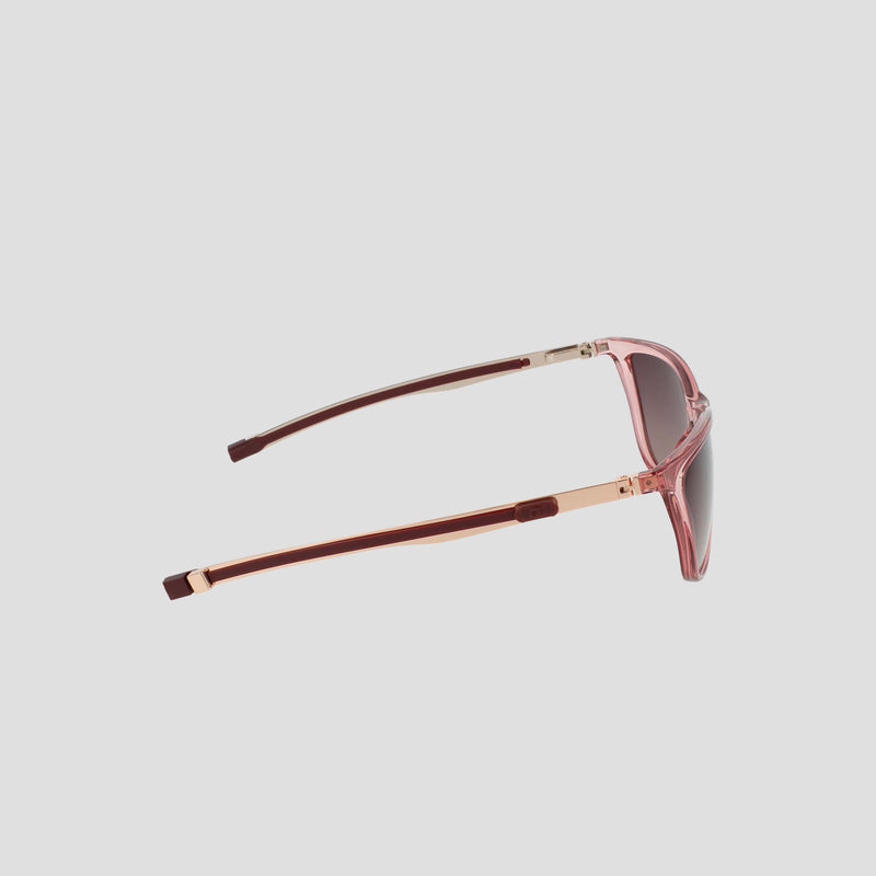 Side view of the Champion Women's Polarized Retainer Rectangle sunglasses in pink, featuring gold-toned hinges and dark polarized lenses, showcasing an athleisure-inspired eyewear style against a plain light gray background.