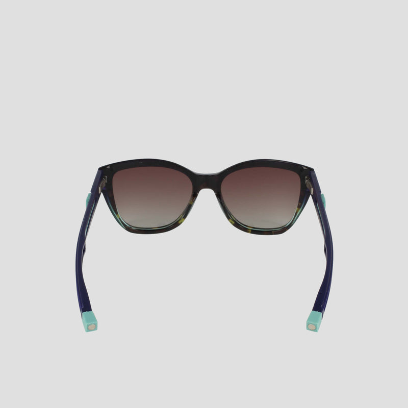 The Champion Women's Polarized Retainer Square sunglasses feature dark gradient lenses, black handmade acetate frames, and navy blue arms with light blue tips, shown from the back on a plain white background.