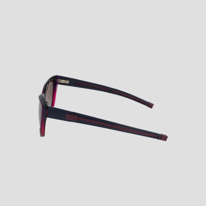 The Champion Women's Polarized Retainer Square sunglasses feature dark lenses and thick, bold purple and red arms, displayed from a side angle on a plain light gray background.