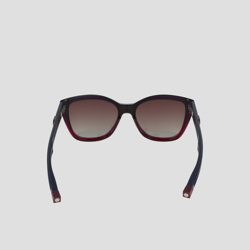 The Champion Women's Polarized Retainer Square features bold cateye sunglasses with dark gradient polarized lenses, black handmade acetate frames, and red accents on the arms and lower rims, displayed front-facing against a plain light background.