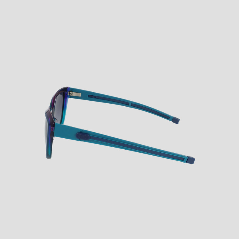 Side view of Champion Women's Polarized Retainer Square sunglasses in blue handmade acetate with thick square frames and polarized dark lenses, shown against a plain light gray background.