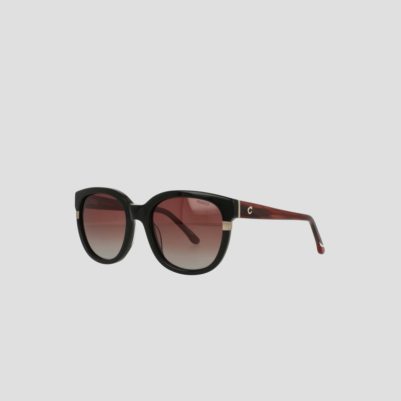 The Champion Women's Polarized Curvaceous Square sunglasses feature large, rounded square frames crafted from luxury acetate, paired with gradient burgundy lenses. Set against a plain light gray background, these black sunglasses have dark temples accented with subtle gold details near the hinges. The RX-able design combines elegance and versatility for any occasion.