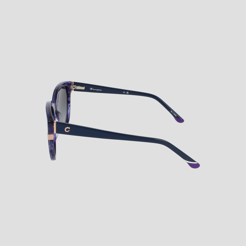 Side view of the Champion Women's Polarized Curvaceous Square sunglasses featuring a stylish dark purple acetate frame, gold accents, and a small gold C on the temple, set against a light gray background.