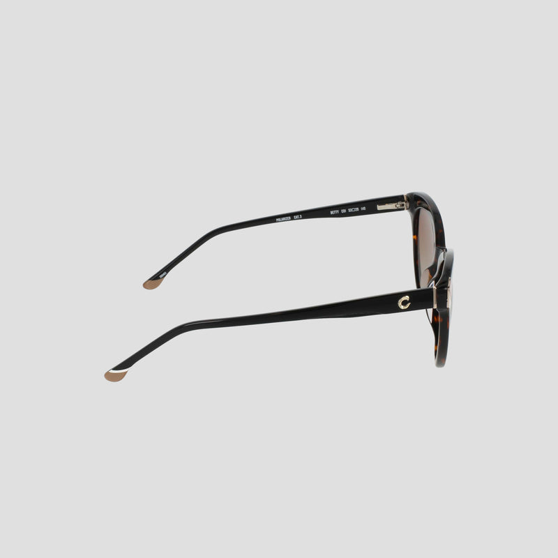 Side view of the Champion Women's Polarized Cateye sunglasses featuring round brown-tinted polarized lenses, gold accents on the temples, and beige tips at the ends of the arms, displayed against a plain light gray background.