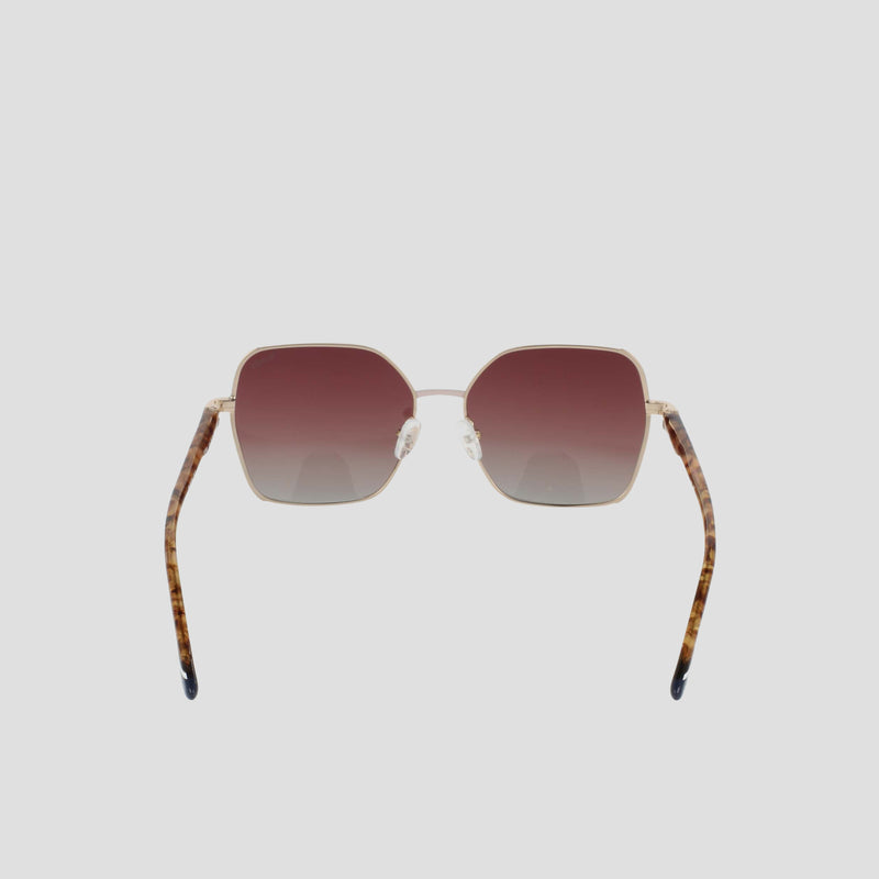 The Champion Women's Polarized Boho Square sunglasses feature gold frames, gradient brown polarized lenses, and tortoiseshell-patterned temple arms for a modern glam look. Displayed on a plain white background, the sunglasses are shown facing forward with their arms slightly angled outward.
