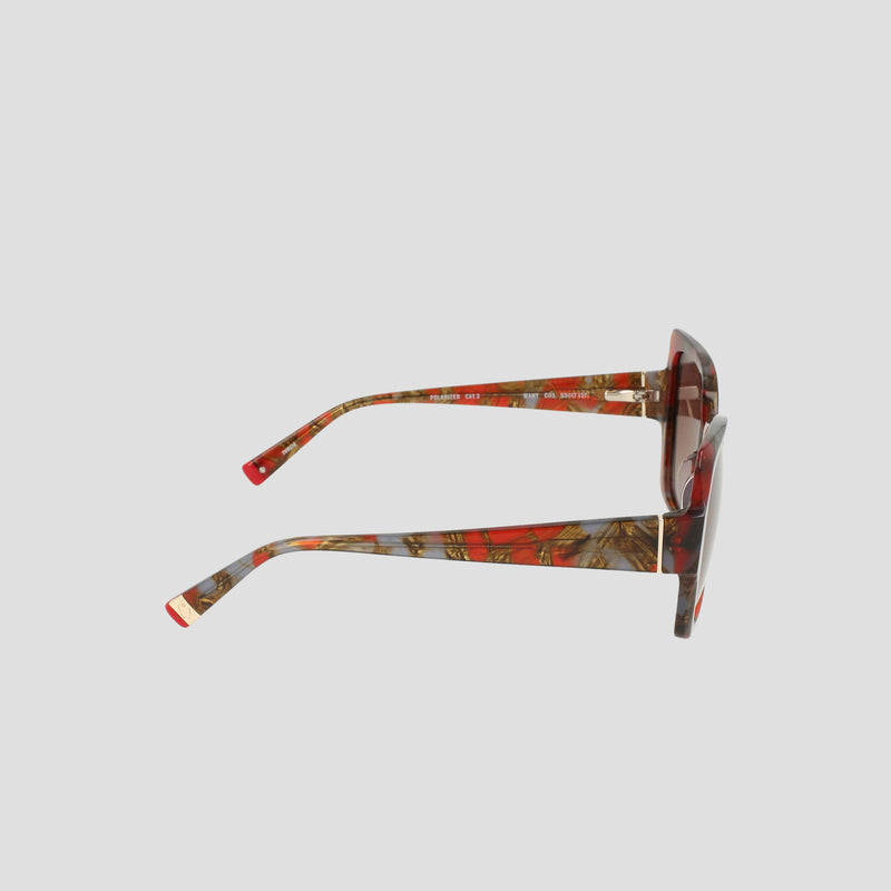 Side view of Champion Women's Polarized Oversized Butterfly eyewear, featuring red and brown marbled acetate frames handcrafted for a minimalist look, with dark polarized lenses, shown against a plain light background.