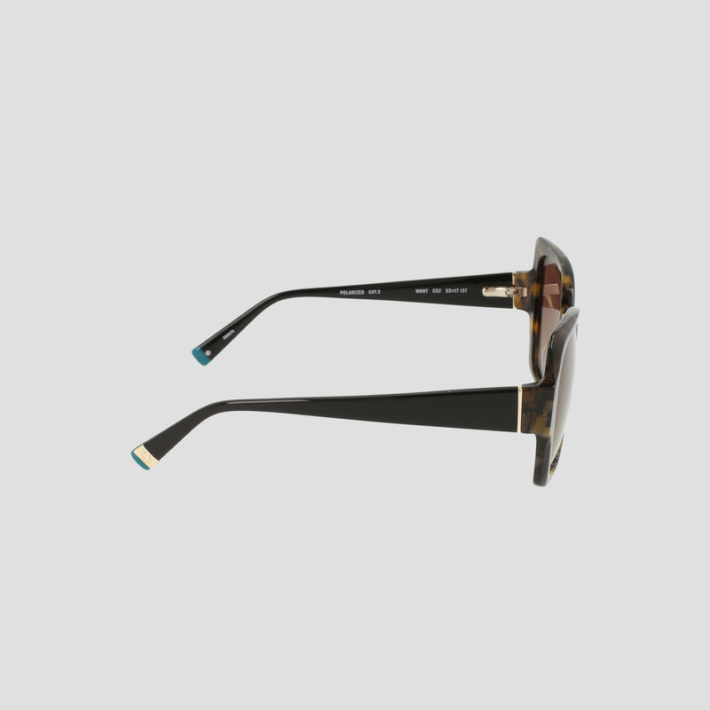 Side view of Champion Women's Polarized Oversized Butterfly sunglasses in handmade tortoiseshell acetate, featuring thick black arms with gold accents near the hinges and turquoise tips, displayed on a plain light background. These minimalist frames combine style and function.
