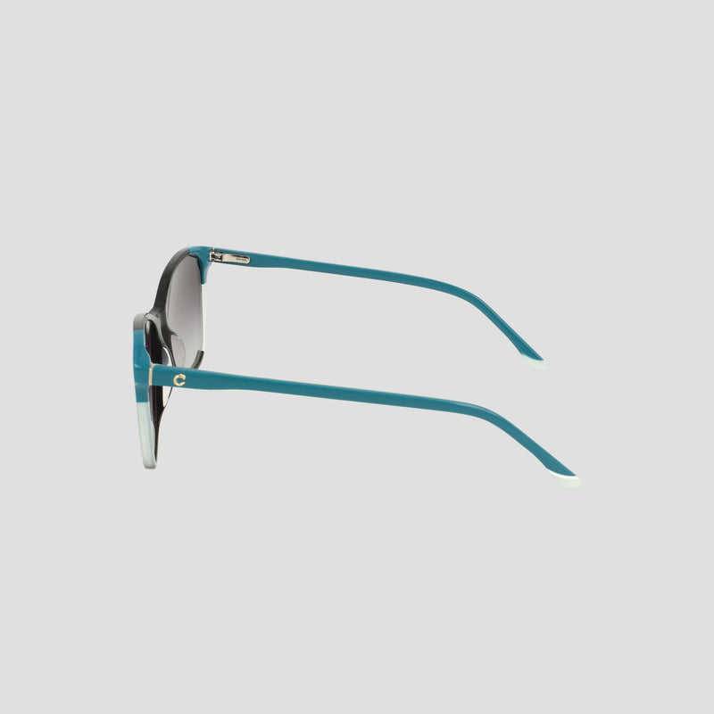 Side view of teal-framed Champion Women's Polarized Catty Square sunglasses featuring dark polarized lenses and white-tipped arms, crafted from handmade acetate, displayed against a plain light gray background.
