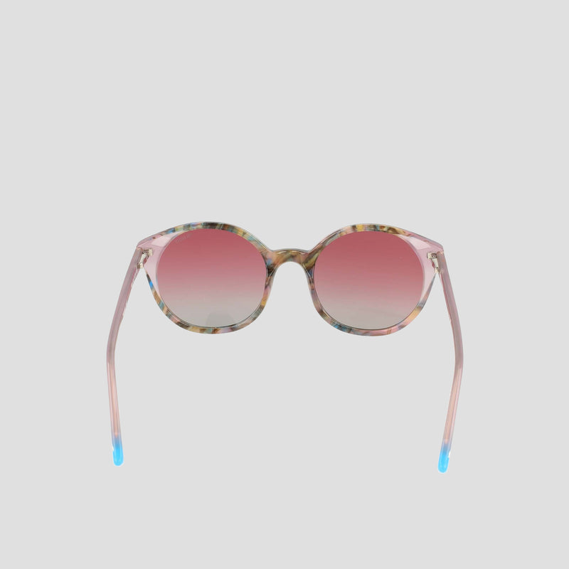 Champion Women's Polarized Flirty Round sunglasses featuring pink gradient polarized lenses, a translucent pink acetate frame, and blue tips on the arms, displayed on a plain light gray background.