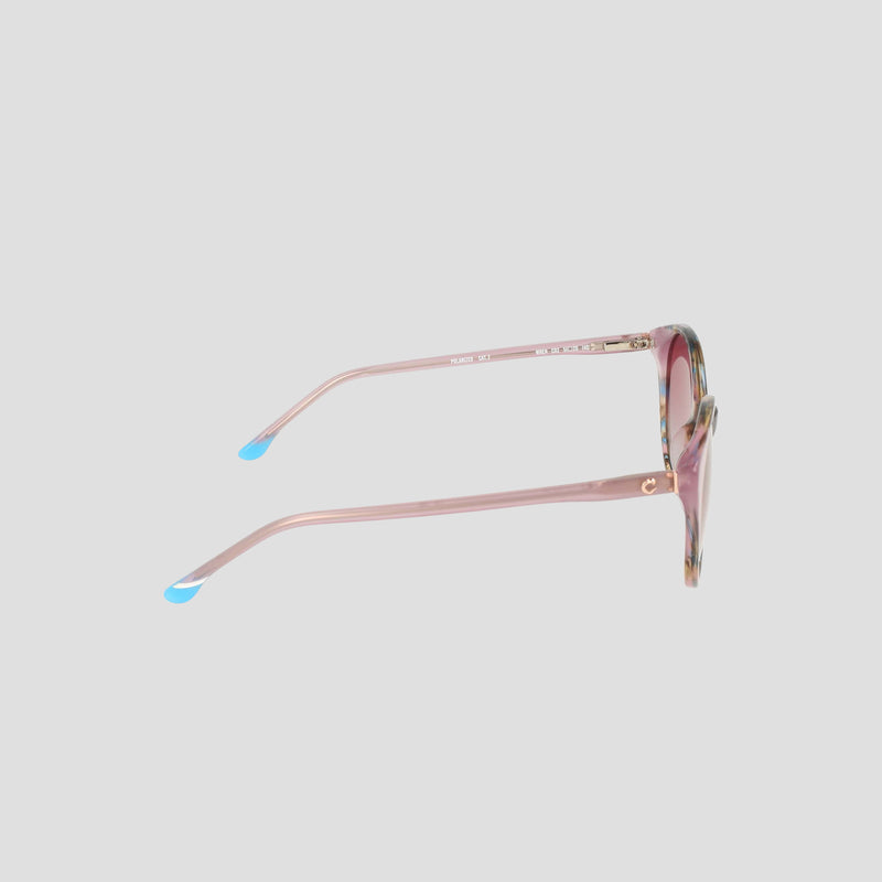 The Champion Women's Polarized Flirty Round sunglasses feature a pink cat-eye silhouette with blue-tipped acetate arms, displayed from the side against a plain light gray background.
