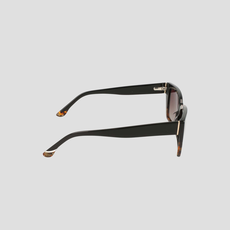 Side view of Champion Women's Polarized Slim Rectangle sunglasses in black, showcasing handmade acetate frames with thick arms, brown tortoiseshell accents, and laminated color block tips, set against a light gray background.