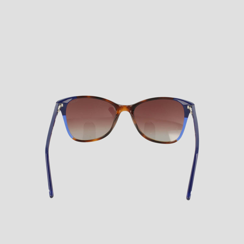 A pair of Women's Polarized Catty Square sunglasses by Champion, featuring gradient brown polarized lenses and blue, RX-able frames crafted from handmade acetate eyeglasses material for enhanced durability and comfort. The stylish design is shown from the front against a plain light background.