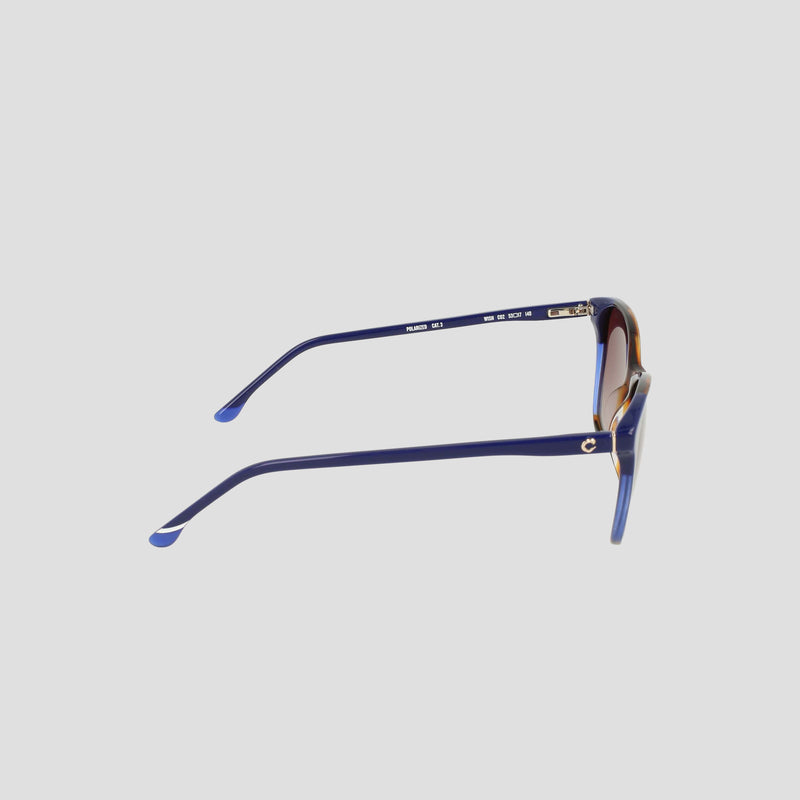 Side view of the Women's Polarized Catty Square sunglasses by Champion, featuring blue and gold accents, slightly curved arms, tinted polarized lenses, and an RX-able frame, displayed on a light gray background.