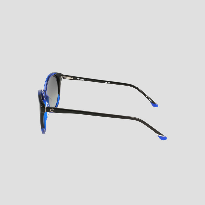 Side view of Champion Women's Polarized Flirty Round sunglasses in black, featuring blue accents on the frames and temple tips, handcrafted from premium handmade acetate with polarized lenses, set against a plain light gray background.