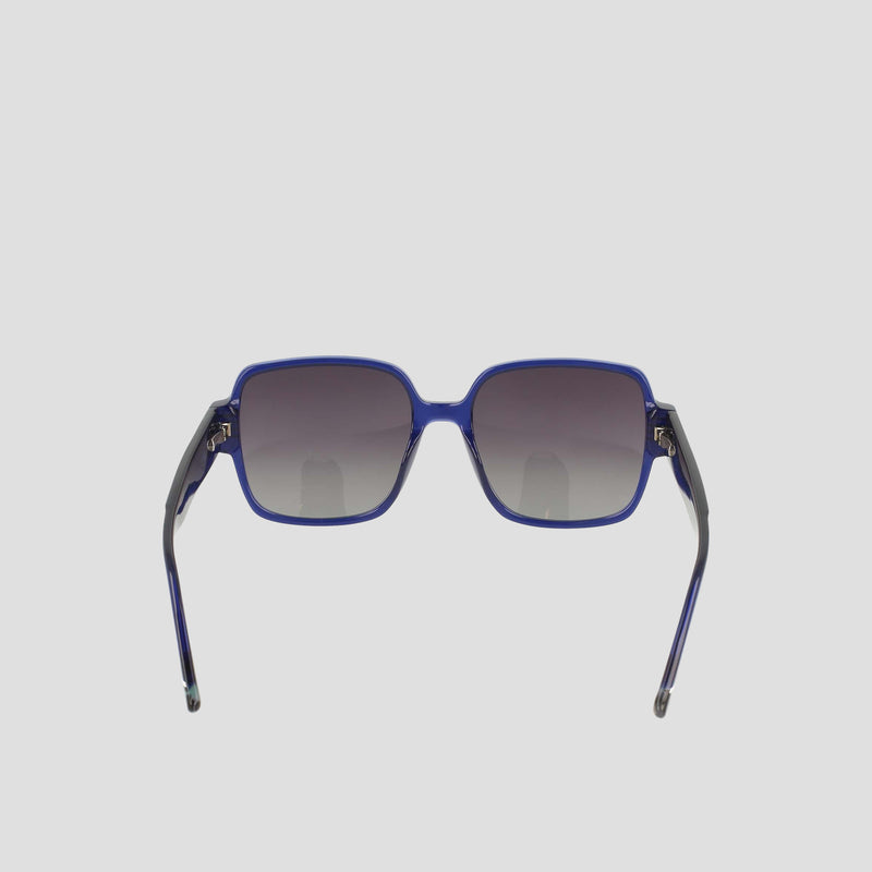 The Champion Women's Polarized Glam Square sunglasses feature blue oversized square frames, dark gradient polarized lenses, and thin black acetate arms, shown facing forward on a plain light background.