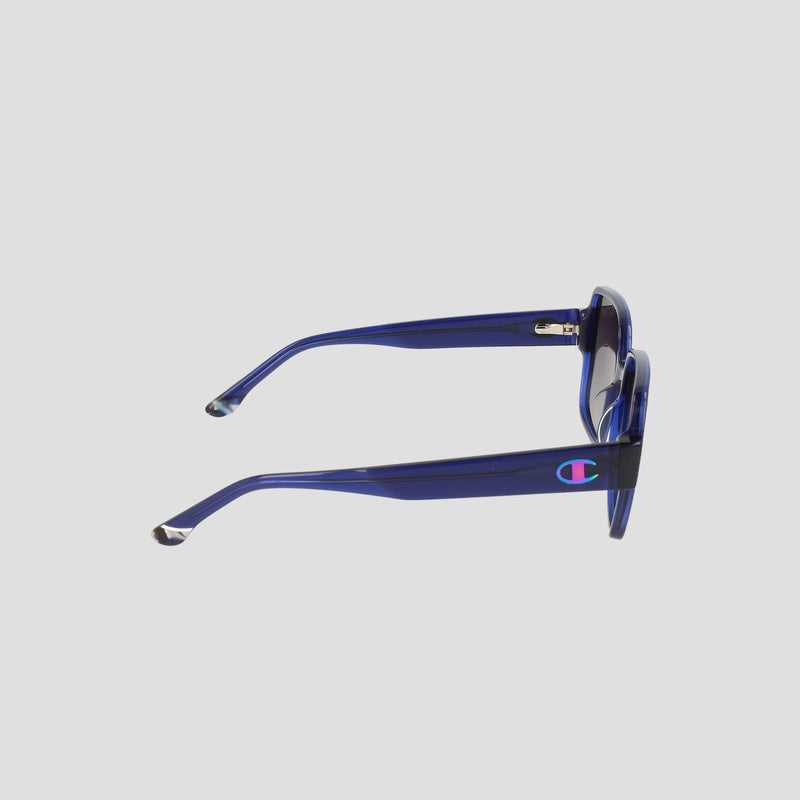 Side view of Champion Women's Polarized Glam Square sunglasses in transparent blue handmade acetate, featuring thick arms, a colorful C logo on the temple, and an oversized modern square frame.