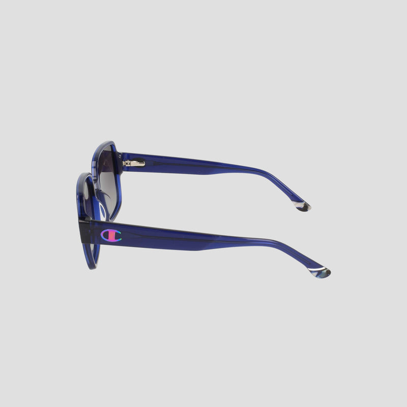 Side view of Champion Women's Polarized Glam Square sunglasses, featuring oversized blue handmade acetate frames, dark polarized lenses, slightly curved arms with black tips, and Champion logo accents on a light gray background.