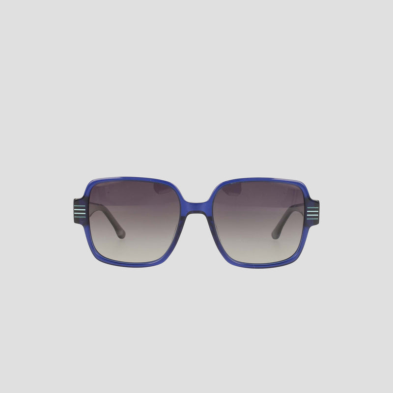 The Champion Women's Polarized Glam Square sunglasses feature an oversized square blue handmade acetate frame with dark gradient polarized lenses. Curved arms sport decorative stripes on the upper corners, set against a plain light background.