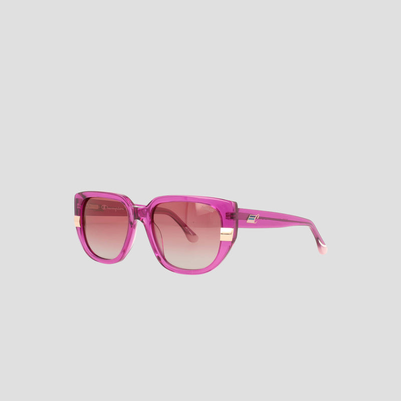 Champion Women's Polarized Modified Cateye sunglasses in pink feature an oversized, modern square silhouette with gradient polarized lenses and elegant gold temple accents, expertly crafted from handmade acetate and showcased against a plain light gray background.