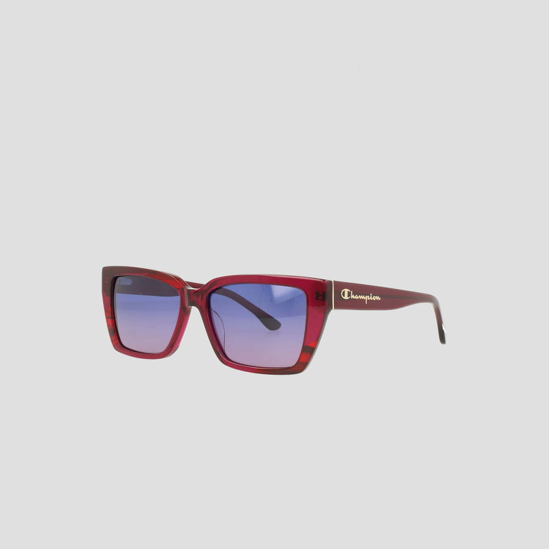 The Women's Polarized Slim Rectangle sunglasses by Champion feature red square frames, blue gradient lenses, and a white Champion logo on the temples. Made from handmade acetate, they are shown against a plain light gray background.