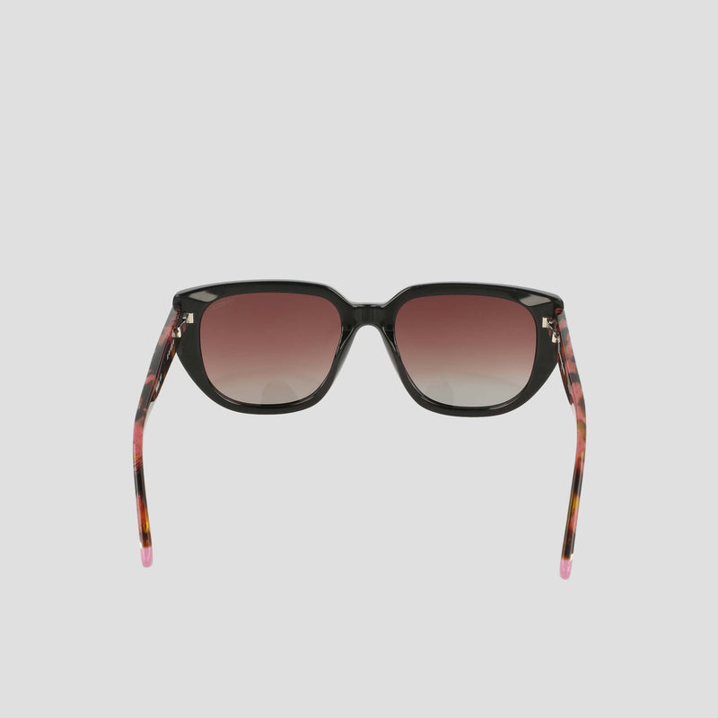 Introducing the Champion Women's Polarized Modified Cateye sunglasses, featuring black frames, gradient pink-tinted polarized lenses, and tortoiseshell arms with pink tips—displayed against a plain white background.