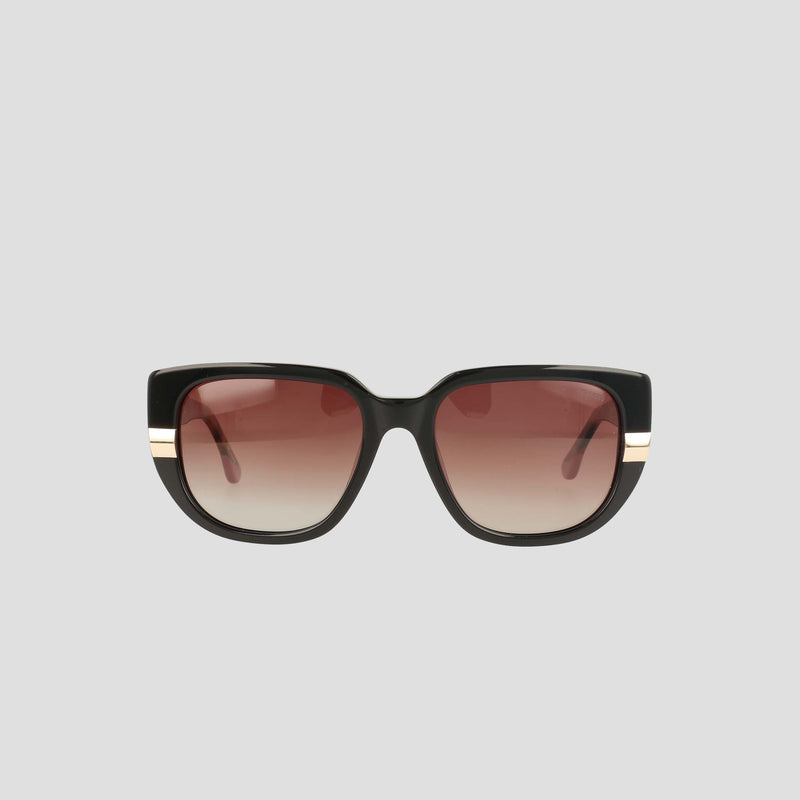 The Champion Women's Polarized Modified Cateye features black handmade acetate frames in a refined shape, paired with brown gradient polarized lenses and accented by elegant gold stripes along the arms—an ideal choice for those seeking luxurious eyewear. Displayed on a plain light gray background.