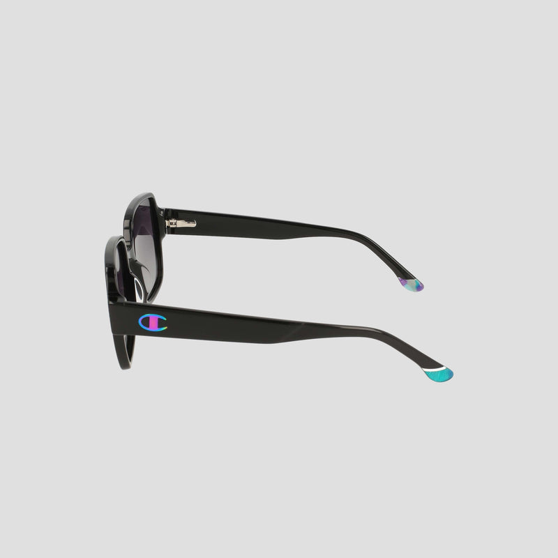 The Women's Polarized Glam Square by Champion features oversized black square frames, thick handmade acetate arms with gradient blue-green tips, and a colorful Champion logo on the side. Set against a plain light gray background.