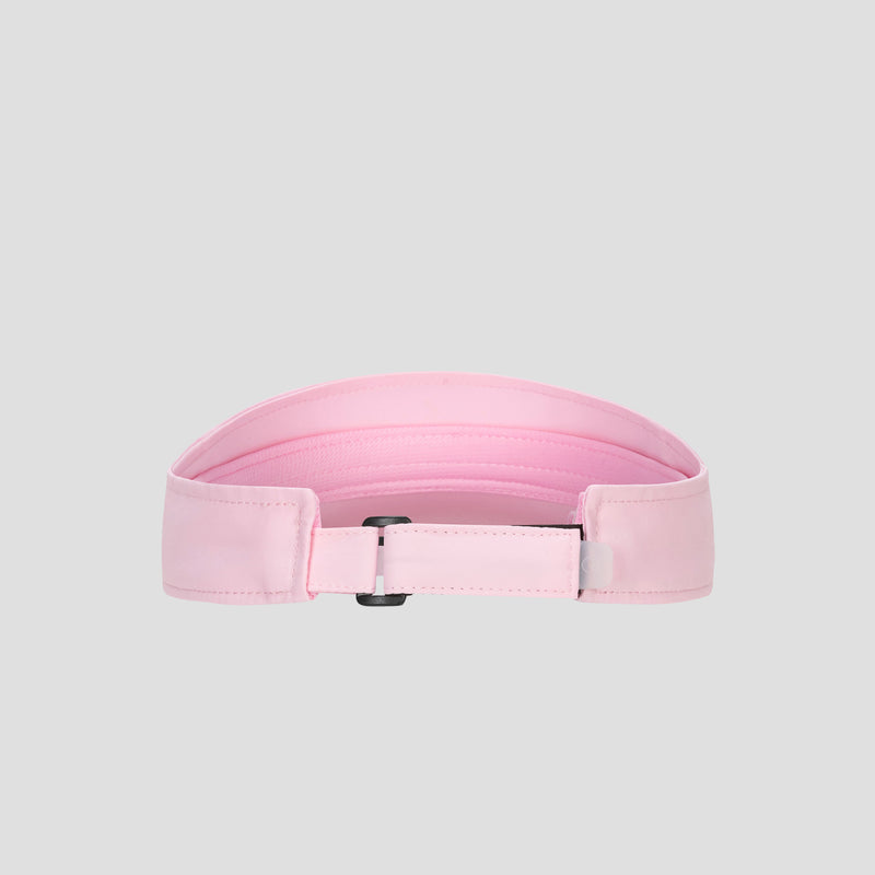 A light pink Champion Adjustable Visor featuring stitching detail, a rectangular black buckle, and a smooth texture offers both style and an adjustable fit, displayed on a plain gray background.
