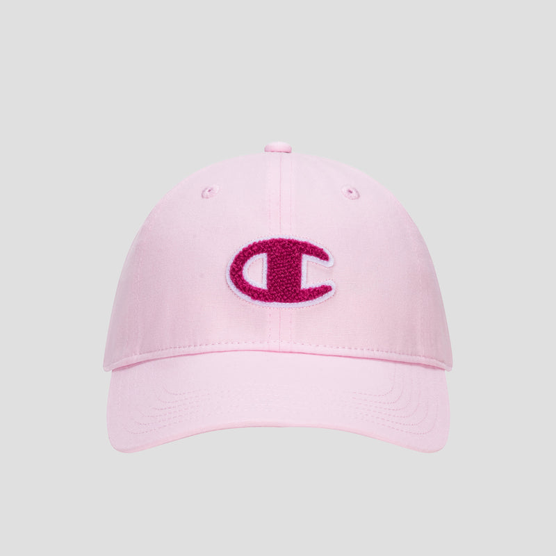 Champion Amber Chenille Adjustable Baseball Cap in light pink, featuring an unconstructed fit and a textured dark pink chenille “C” logo patch on the front, crafted from premium slub canvas and displayed against a plain gray background.