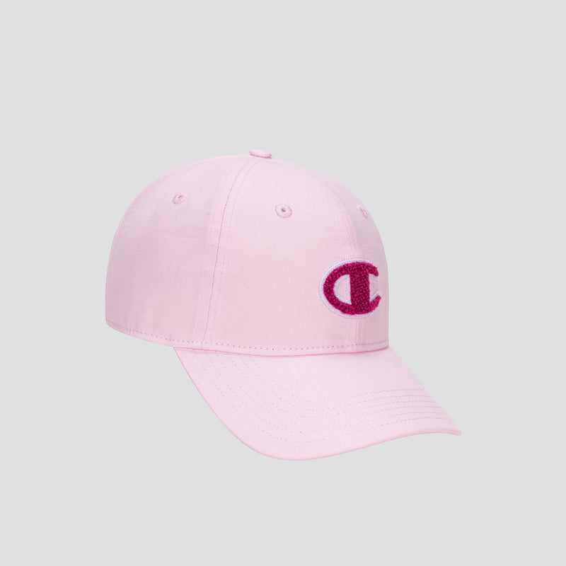 The Champion Amber Chenille Adjustable Baseball Cap features a light pink, unconstructed fit with a curved brim, crafted from premium slub canvas. On the front, it displays a dark pink chenille “C” logo patch. The cap is presented here against a plain gray background.