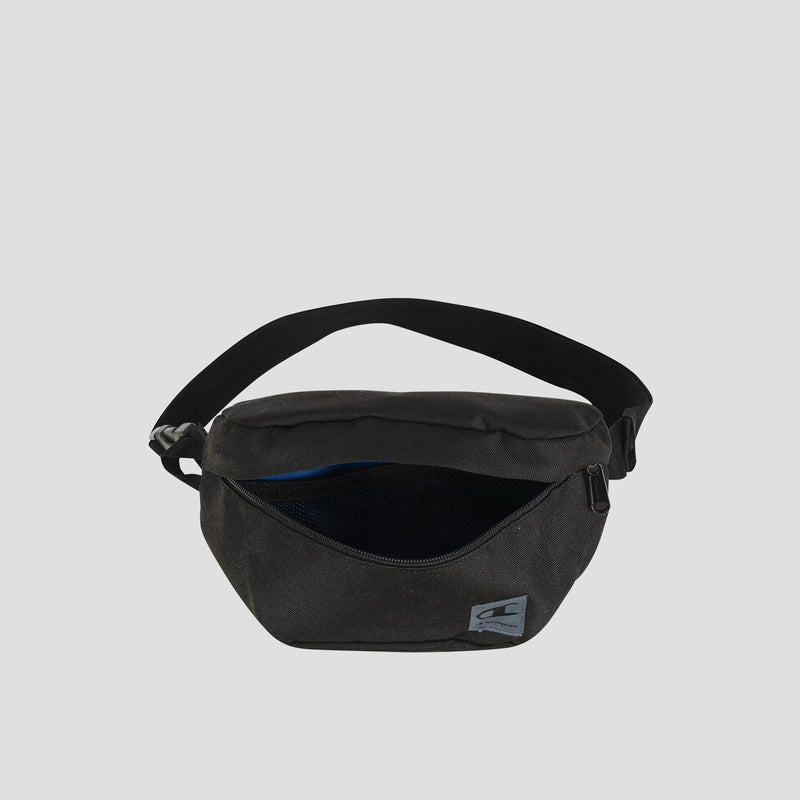The Champion Atlas Waist Pack in black features a zippered main compartment that is partially open to reveal an inner mesh pocket. This bag includes an adjustable strap, adventure-ready storage for your essentials, and a small rectangular Champion logo patch on the front.