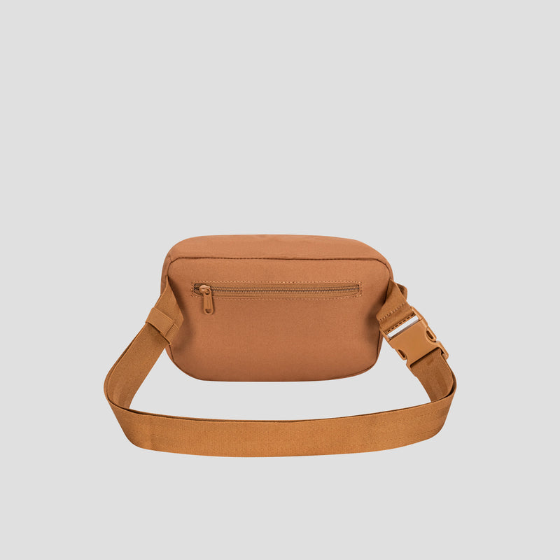 Champion Atlas Waist Pack in tan canvas, featuring an adjustable strap and a front zippered pocket for hands-free convenience, displayed against a plain light gray background.