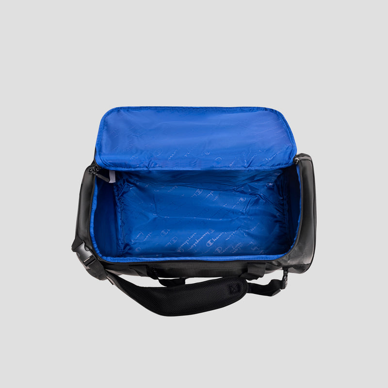 Open black and blue Champion Approach Convertible Duffel insulated lunch bag with blue interior lining, unzipped and empty, shown from above on a plain gray background—its versatile design evokes the look of a compact gym bag or convertible duffel.