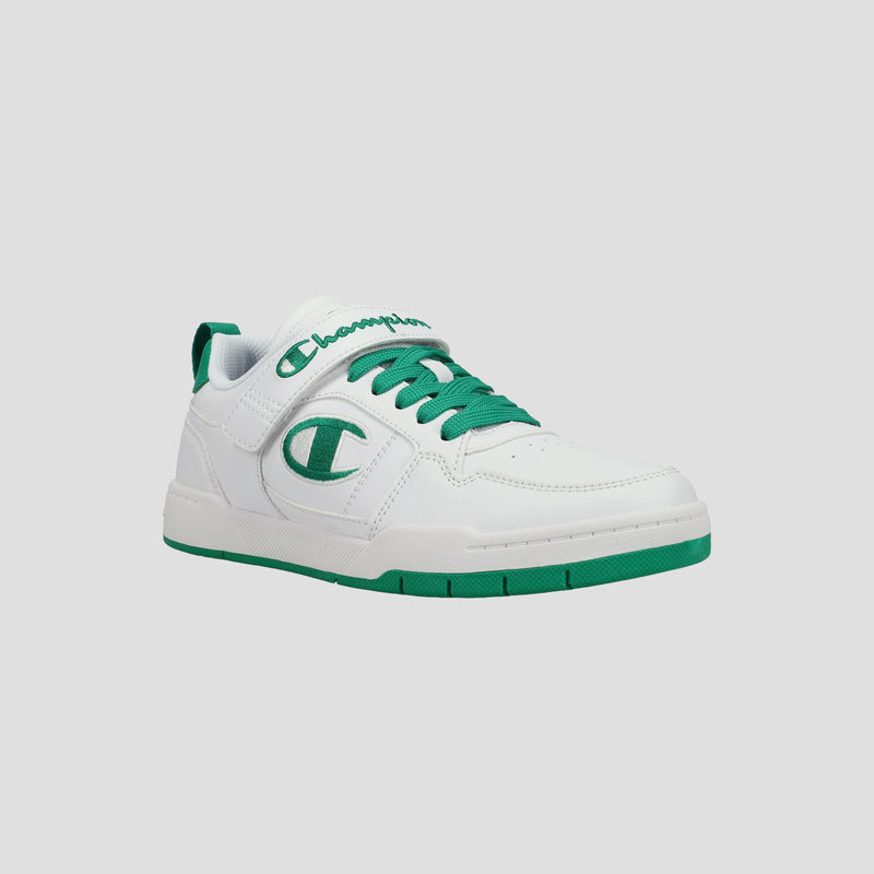 The Kids' Arena Power Low by Champion is a white kids' sneaker with green laces, sole, and accents. A large C logo decorates the side and "Champion" in green script appears on the tongue, showcasing classic Champion style.
