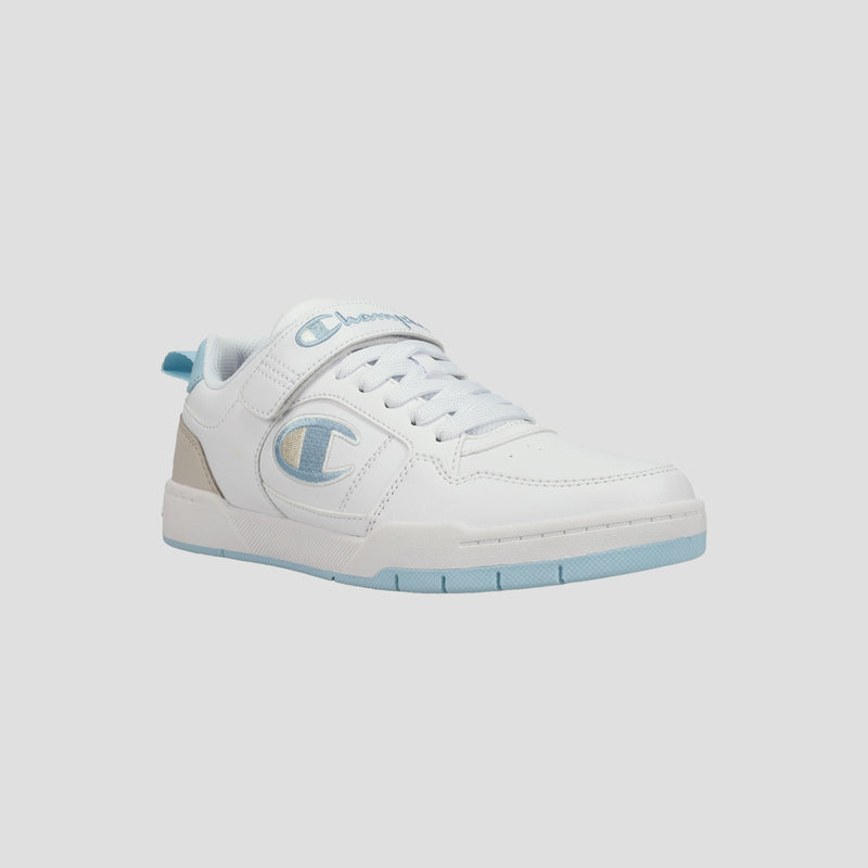 The Champion Kids' Arena Power Low sneaker features a white low-top design with light blue accents, a beige heel tab, the Champion logo on the side, white laces, and a light blue sole. Perfect for classic style on a light gray background.