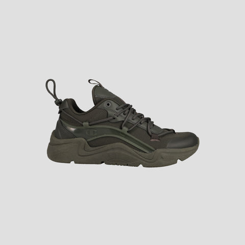 The Champion Men's Hyper C Pilot is a dark green and black lifestyle sneaker with a chunky sole, durable mesh upper, synthetic overlays, lace-up front, and pull tabs, shown side profile on a light gray background.