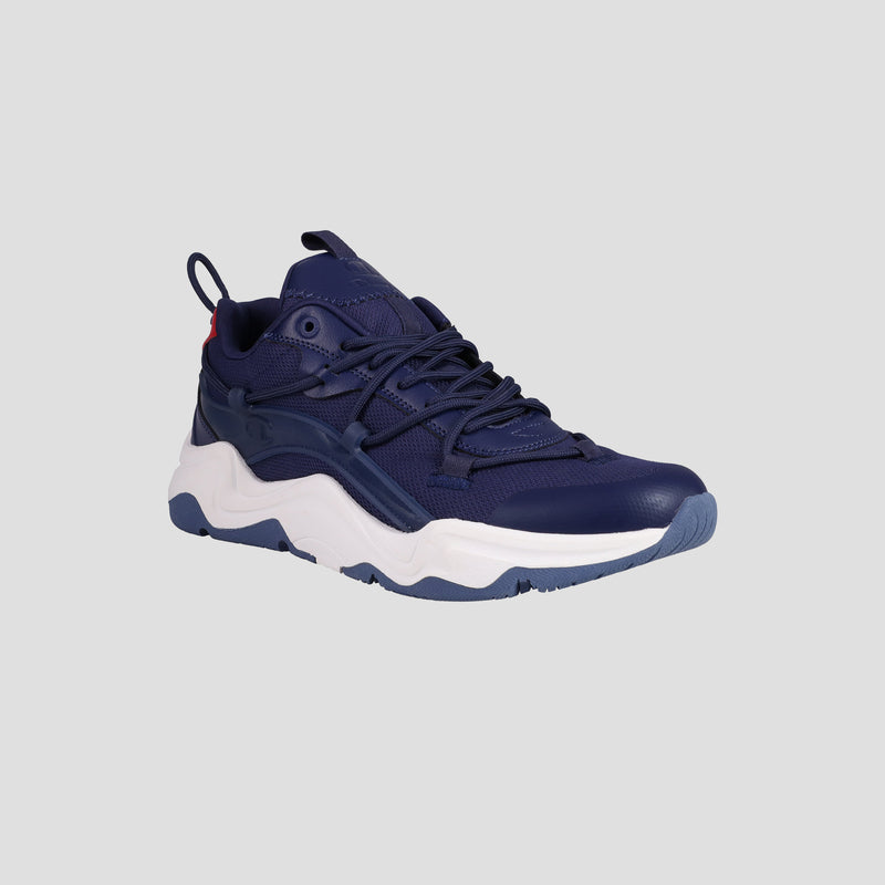 The Champion Men's Hyper C Pilot sneaker features a navy mesh and leather upper, dark blue laces, and a chunky white/light blue sole, displayed at an angle on a plain light gray background.