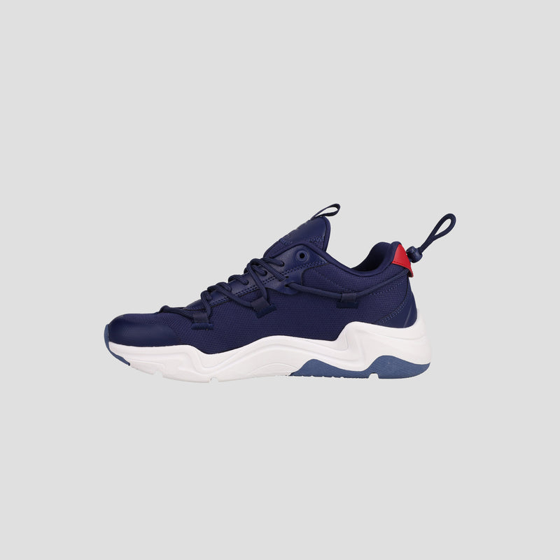 The Champion Men's Hyper C Pilot is a navy blue lifestyle sneaker with a white sole, blue outsole detail, durable mesh upper, black laces, and a red heel accent, shown on a plain light gray background.