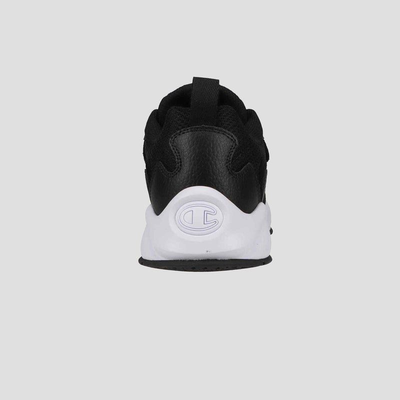 The Champion Men's 9318 Vale sneaker is shown from the back, with a white sole featuring an embossed C logo on the heel and a sleek black leather and mesh upper, set against a plain gray background.