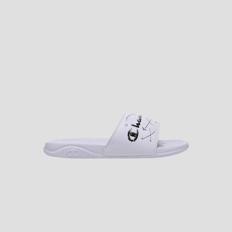 The Champion Men's Mega SFB Slide is a white sandal with a wide strap featuring black abstract face art. It has a contoured footbed, textured sole, and minimalist design, displayed on a plain light gray background.