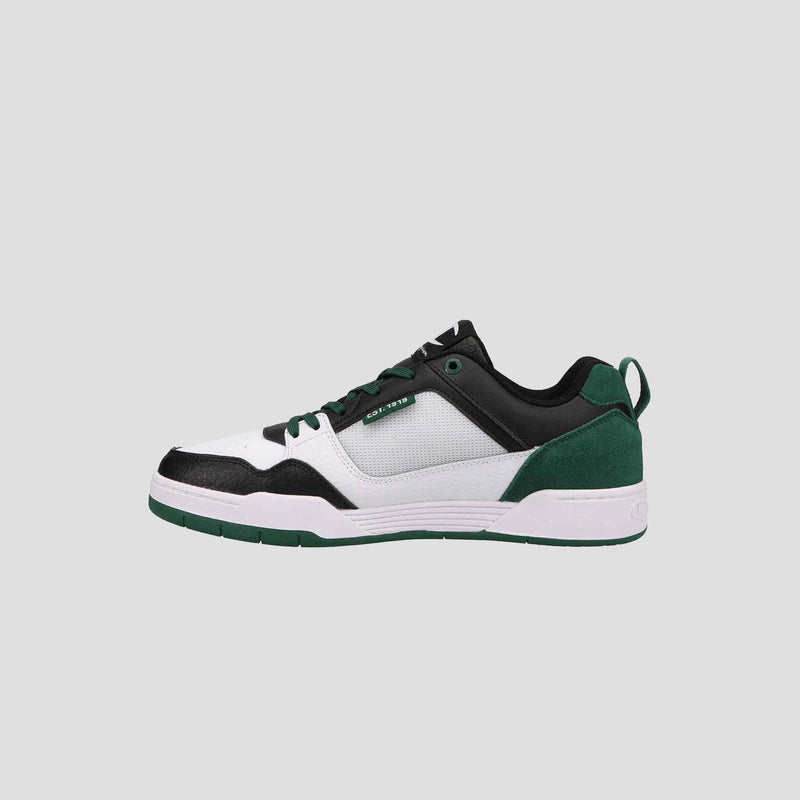 The Champion Men's 5-on-5 Low is a minimalist low-top sneaker with a white mesh upper, black leather overlays, green suede heel accents, green laces, cushioned collar, and a white and green rubber sole on a light gray background.