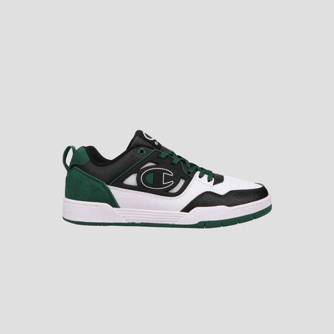 The Champion Men's 5-on-5 Low sneaker in black, white, and dark green sports a minimalist design with a large C logo, cushioned collar, green laces, and a white/green sole. Set against a light gray background.